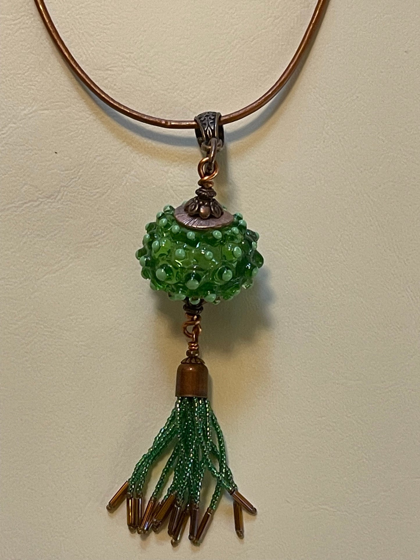 Artisanal Bead with Handmade Tassel of Seed Beads with Copper-Colored Leather Cord